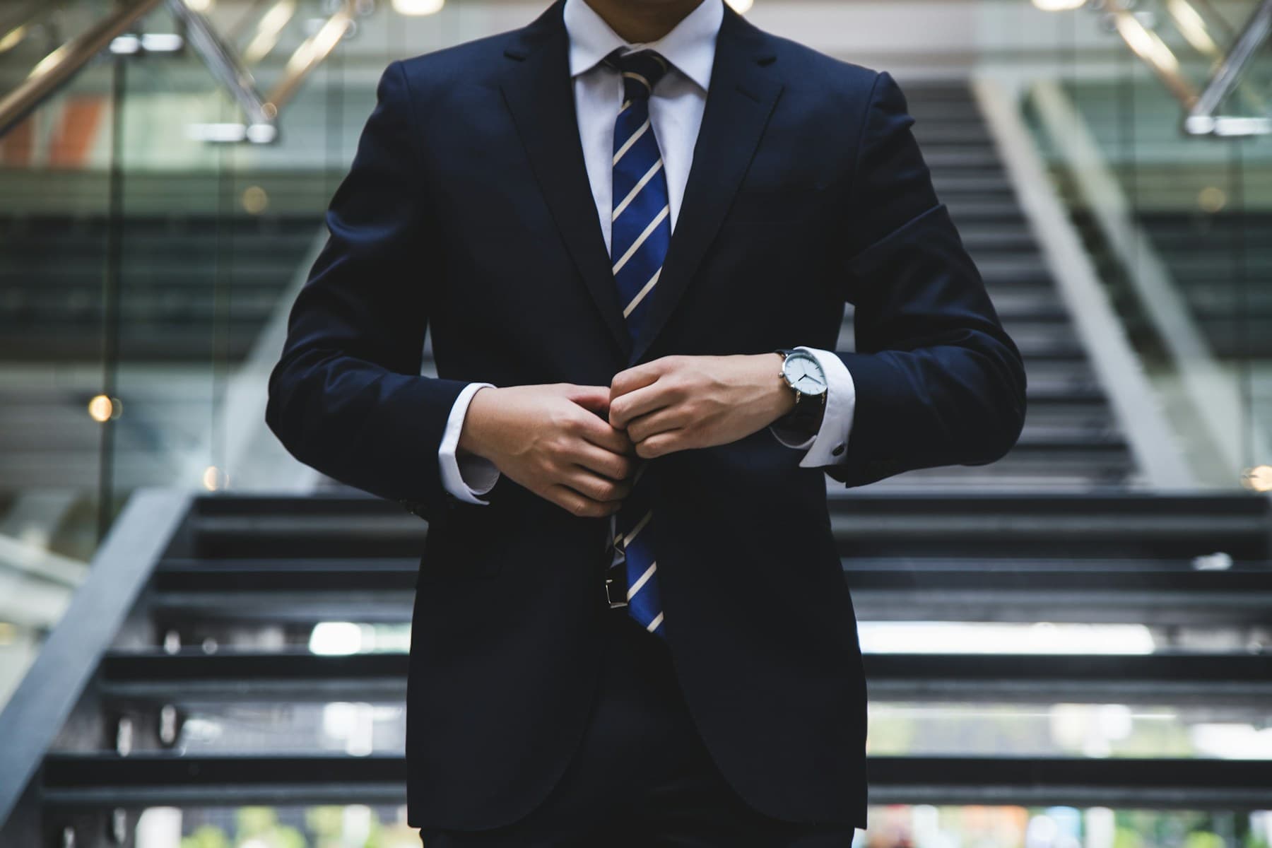 Professional wearing a navy suit and tie